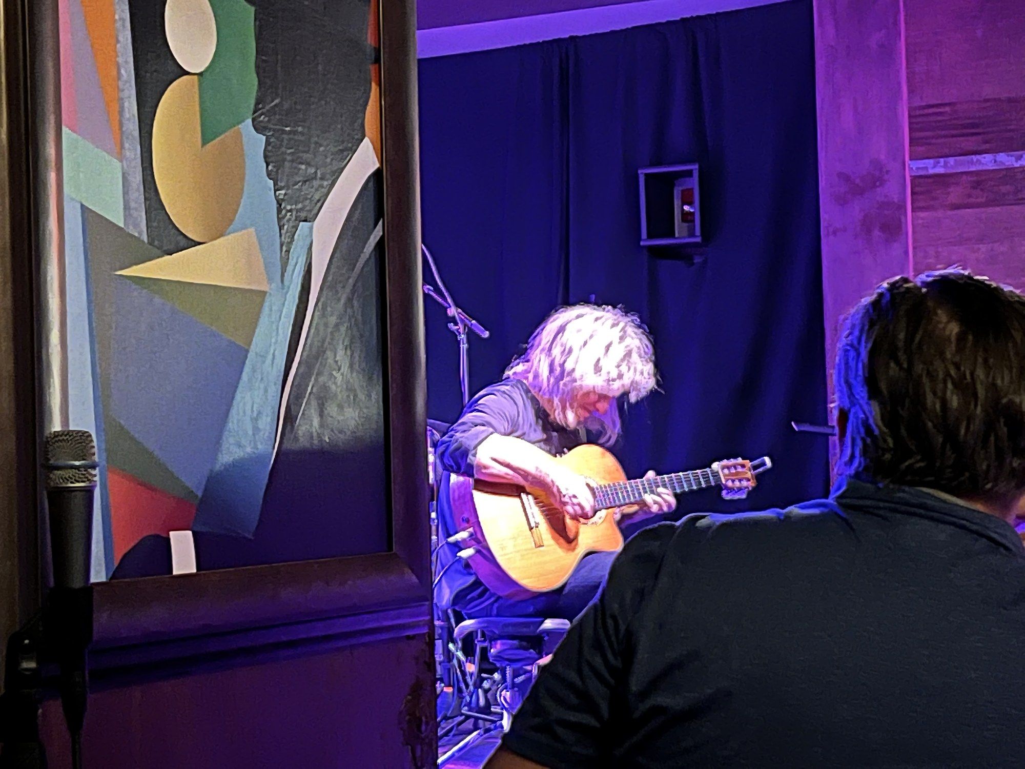 Pat Metheny seated under purple light playing a nylon-string acoustic guitar at Keystone Korner in Baltimore, September 19, 2022